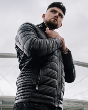 Kurtka skórzana męska w czarnym kolorze z pikowanym wzorem i zamkami bocznymi, dopasowany krój z kołnierzem